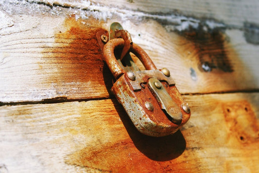 a rusted lock on a wooden chess