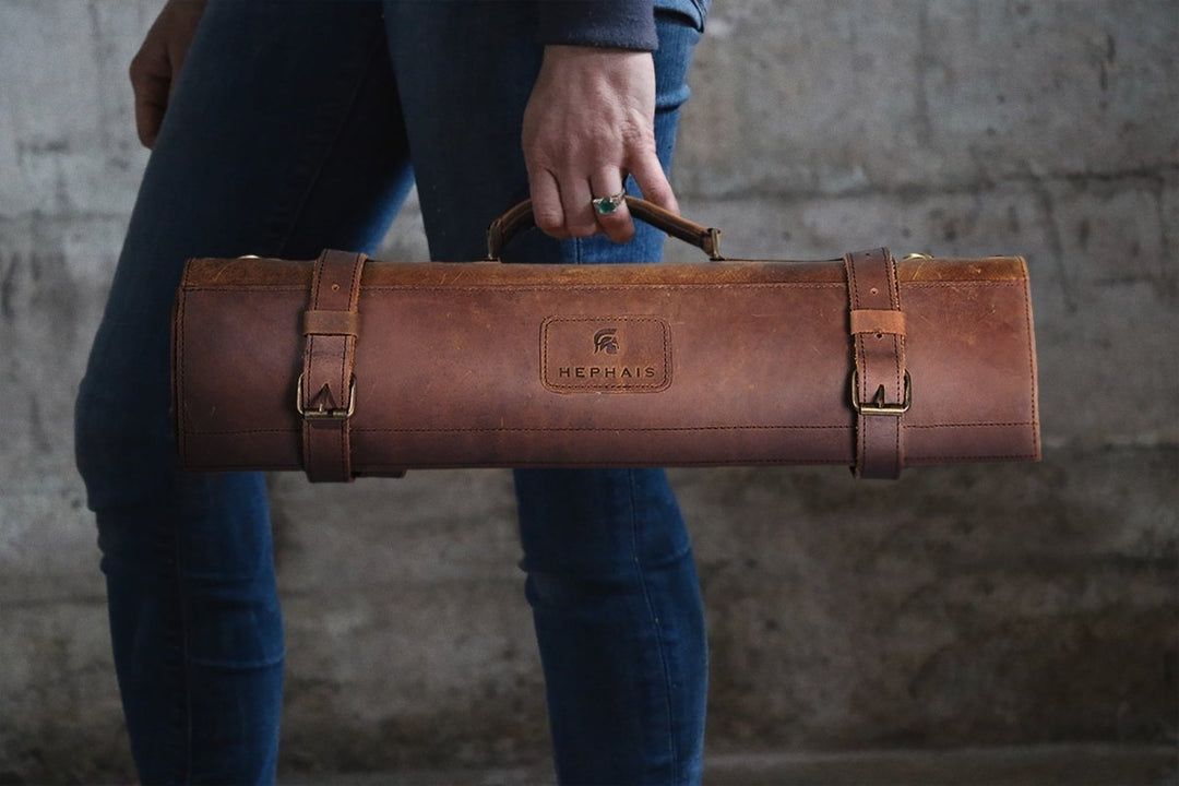 leather chef knife bag being held by a man in a nice suit