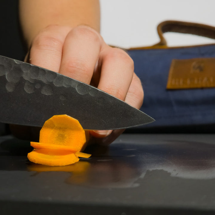 Chef knife slicing carrot