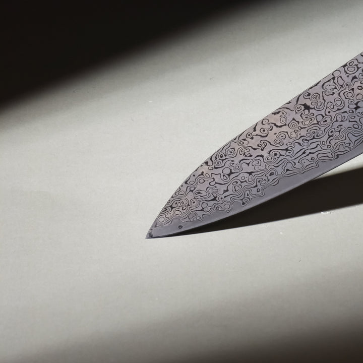 Close-up of Knox Chef Knife Handle and Matte Damascus Blade Design